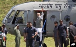 Indian Prime Minister Narendra Modi, center, arrives for an election campaign rally in Along, Arunachal Pradesh, India, March 30, 2019. Poll workers for India's general elections will likely use a helicopter to reach voters in that state.
