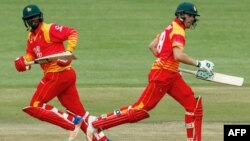 FILE: Zimbabwe's batsman Ryan Murray (R) runs between the wickets with teammate Tendai Chatara (L) during the first one day international (ODI) cricket match between Pakistan and Zimbabwe at Queens Sports Club in Bulawayo on July 13, 2018.