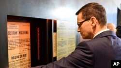Polish Prime Minister Mateusz Morawiecki visits the Ulma Family Museum of Poles Who Saved Jews During WWII, in Markowa, Poland, Feb. 2, 2018. New legislation in Poland seeks to regulate speech regarding the Holocaust. 