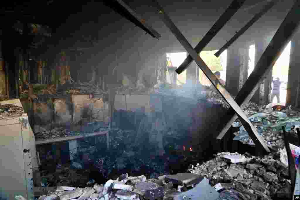 Smoke rises from the reception room of the U.S. embassy that was burned by Pro-Iranian militiamen and their supporters, in Baghdad, Iraq, Jan. 1, 2020.