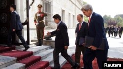 U.S. Secretary of State John Kerry (R) arrives for a second meeting with Afghan President Hamid Karzai at the Presidential Palace in Kabul, October 12, 2013.