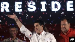 Colorado Party's presidential candidate Horacio Cartes, waves to supporters in Asuncion, Paraguay, April 21, 2013.
