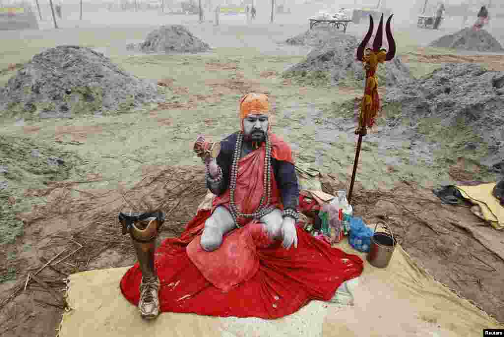 A Sadhu, or Hindu holy man, sits on the banks of river Ganges with his prosthetic leg on a cold winter morning in the northern Indian city of Allahabad.