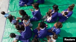 FILE: Prisoners and their children attend a ceremony at Prey Sar prison in Phnom Penh, Cambodia, March 8, 2015. REUTERS/Samrang Pring