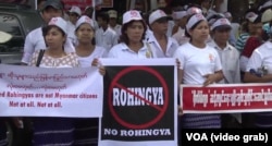 FILE - Demonstrators hold banners outside the U.S. Embassy in Yangon, Myanmar, April 28, 2016, to protest against the embassy's use of the word "Rohingya."
