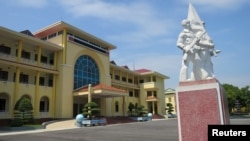 FILE - A statue of soldiers holding Russian-made AK-47 rifles stands outside the headquarters of the Division 308 special military forces, in Xuan Mai town, outside Hanoi, Vietnam.