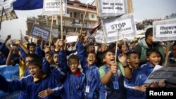 Nepalese students holding placards take part in a protest to show solidarity against the border blockade in Kathmandu, Nepal, Nov. 27, 2015. 