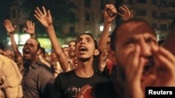 Protesters shout during a demonstration against presidential candidates Mohamed Morsi and Ahmed Shafiq at Tahrir Square in Cairo May 28, 2012.