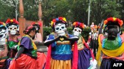 People take part in the Day of the Dead parade along Reforma avenue in Mexico City, on October 27, 2019. 