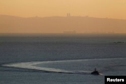 FILE - An Israeli naval vessel sails in the Mediterranean sea near the border with Lebanon, as Mount Carmel and the Israeli city of Haifa are seen in the background, Dec. 16, 2013.