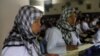 FILE - A migrant worker heading for Middle East countries holds her passport documents at an immigration office in Tangerang, Indonesia's Banten province, in June 2011.