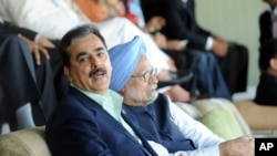 Pakistan's Prime Minister Yusuf Raza Gilani sits with his Indian counterpart Manmohan Singh as they watch the ICC Cricket World Cup semi-final match between India and Pakistan in Mohali, India, March 30, 2011.