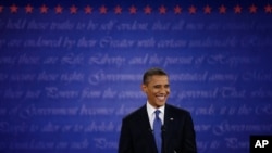 President Barack Obama smiles at moderator Jim Lehrer during the first presidential debate at the University of Denver, Oct. 3, 2012.