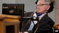 FILE - In this March 6, 2017, photo, Stephen Hawking receives the Honorary Freedom of the City of London. Cambridge University has put Hawking's doctoral thesis online, Oct. 23, 2017. 