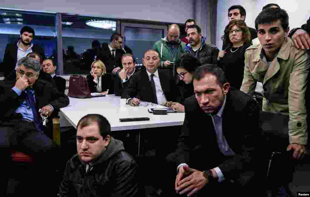 Gursel Tekin (center), main opposition Republican People&#39;s Party (CHP) deputy chairman, watches election results on TV with party members at CHP headquarters in Ankara, March 30, 2014.