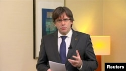 FILE - Sacked Catalan President Carles Puigdemont makes a statement calling for the release of "the legitimate government of Catalonia," after a Spanish judge ordered nine Catalan leaders to be held in custody, Brussels, Belgium, Nov. 2, 2017. 