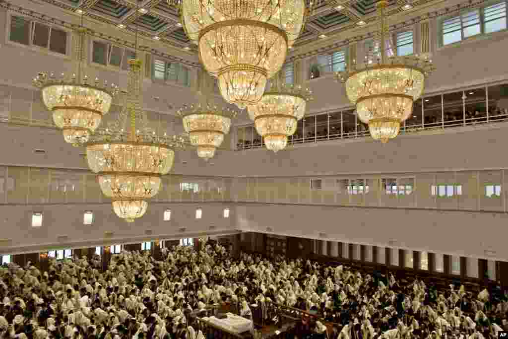 Ultra-Orthodox Jewish men gather during prayers at the Belz yeshiva during the Jewish holiday of Sukkot in Jerusalem. The holiday commemorates the biblical story of the Israelites wandering in the desert for 40 years.