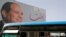 FILE - People ride on a bus as posters with Egypt's President Abdel Fattah al-Sissi are displayed in Cairo, Egypt, March 25, 2018. 