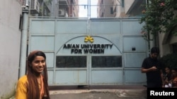 Formin Akter, a Rohingya refugee girl, stands outside the gates of the Asian University for Women on her first day of college in Chittagong, Bangladesh Aug. 26, 2018. 