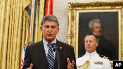 FILE - Sen. Joe Manchin, D-W.Va. speaks during a Presidential Medal of Freedom ceremony for former Boston Celtics NBA basketball player and coach Bob Cousy, at the White House, Washington, Aug. 22, 2019.