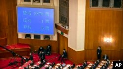 A video screen shows the results of the vote on a piece of national security legislation concerning Hong Kong during the closing session of China's National People's Congress (NPC) in Beijing, China, May 28, 2020.