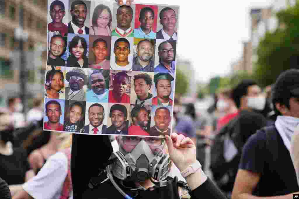 Demonstrators gather to protest the death of George Floyd, a black man who died in police custody in Minneapolis, at the corner of 14th and U streets in Washington, Friday, May 29, 2020. (AP Photo/Evan Vucci)