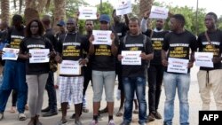 FILE - Anti-slavery militants demonstrate, Aug. 3, 2016, in Dakar against the imprisonment of fellow activists in Mauritania as they hold placards with their names.