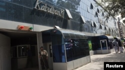 FILE - Security guard stands outside main office of Kabul Bank, September 1, 2010.