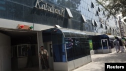 A security guard stands outside the main office of Kabul Bank, September 1, 2010. 