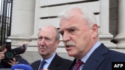 Independent Alliance Ministers, Shane Ross (L) and Finian McGrath speak to the press on arrival at Government buildings for a cabinet meeting in Dublin on Sept. 2, 2016 on whether to appeal an EU order mandating Ireland to collect €13 billion in taxes fro