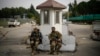 Syrian fighters guard the entrance of the Lakatia civilian airport located in the town of Hmeimim, southeast of Latakia, Syria, Dec. 16, 2024.