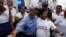 Peruvian presidential candidate Cesar Acuna (C) greets supporters during a rally at a market in the Brena district of Lima, Jan. 25, 2016.