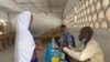 A voter arrives to cast her ballot during the first regional election in Maroua, Cameroon, Dec. 6, 2020. 