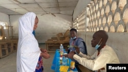 A voter arrives to cast her ballot during the first regional election in Maroua, Cameroon, Dec. 6, 2020. 