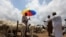 FILE - Men are seen at a livestock market, amid the spread of the coronavirus disease (COVID-19), in Abuja, Nigeria, July 29, 2020. 