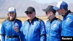 "Star Trek" actor William Shatner, 2nd left, speaks to the news media with the three other crew members after their flight in a capsule powered by Blue Origin's reusable rocket engine New Shepard, on a landing pad near Van Horn, Texas, October 13, 2021.