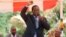FILE: In this image taken on Wednesday Feb, 10, 2016, Zimbabwean Deputy President Emmerson Mnangagwa greets party supporters at the ZANU-PF headquarters in Harare. (AP Photo/Tsvangirayi Mukwazhi)
