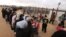 Syrian women wait in line to receive winter aid as UN General Assembly President Mogens Lykketoft visits Zaatari refugee camp in Mafraq, Jordan, Jan. 20, 2016. Jordan says the most recent census counted 1.265 million Syrians in the kingdom, or twice the number of registered Syrian refugees.