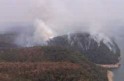 Smoke rises from wildfires, Dec. 27, 2019, in the Blue Mountains, New South Whales, Australia. Firefighters battling wildfires in Australia’s most populous state face increased fire danger thanks to higher temperatures.