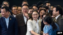 Thailand's new Prime Minister Paetongtarn Shinawatra (centre R), known by her nickname "Ung Ing" and daughter of former prime minister Thaksin Shinawatra, greets Pheu Thai party members during a press conference in Bangkok on August 16, 2024.