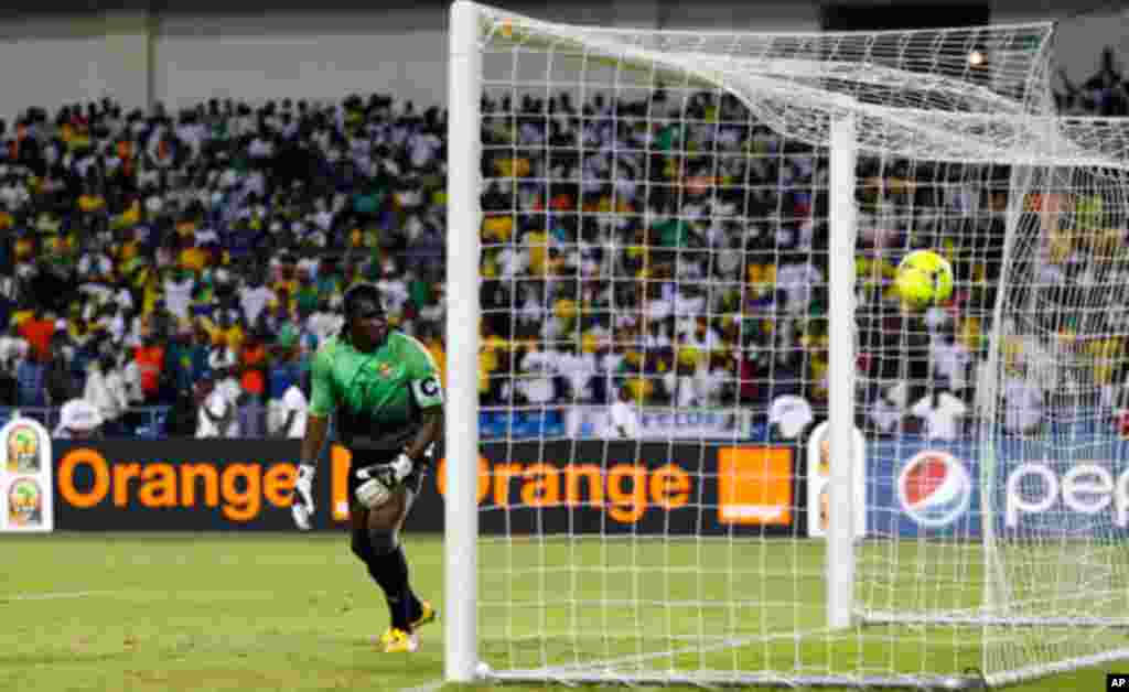 Gabon's Ebang looks on as Morocco's Kharja scores a penalty during their African Cup of Nations soccer match in Libreville