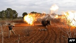 An opposition fighter fires a gun from a village near al-Tamanah during ongoing battles with government forces in Syria's Idlib province on Jan. 11, 2018. 