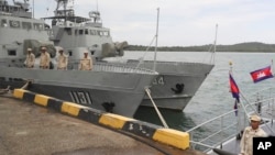 FILE - Cambodian navy troop members stand on a navy boat at Ream Naval Base in Sihanoukville, southwestern of Phnom Penh, Cambodia on July 26, 2019.