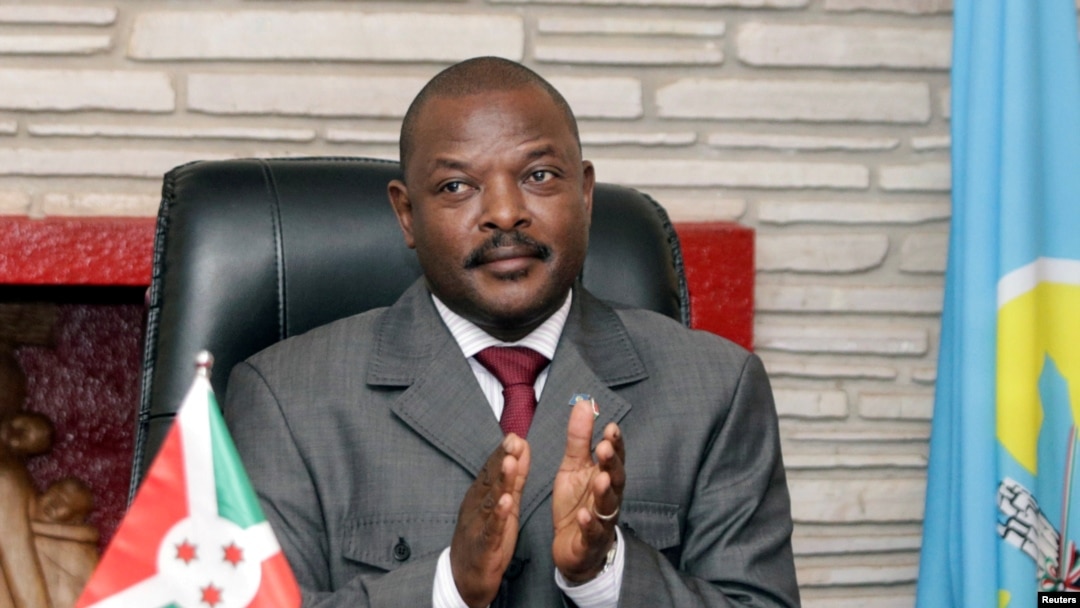 FILE - Burundi President Pierre Nkurunziza claps after signing the new constitution at the Presidential Palace in Gitega Province, June 7, 2018.