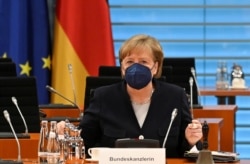 FILE - German Chancellor Angela Merkel takes her seat during the weekly cabinet meeting at the chancellery in Berlin, Germany, May 5, 2021.