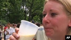 A woman enjoys a cup of raw unpasteurized milk