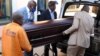 South Africa undertakers load a casket on a hearse