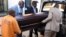 South Africa undertakers load a casket on a hearse