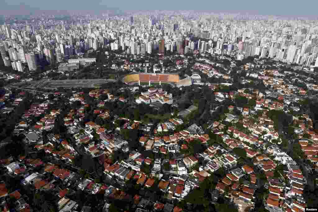 An aerial view of the Pacaembu neighborhood is seen with the skyline of Sao Paulo, Brazil, in the backround, April 12, 2015.