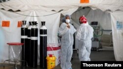 Healthcare workers chat at a temporary ward set up during the coronavirus disease (COVID-19) outbreak, at Steve Biko Academic Hospital in Pretoria, South Africa, January 19, 2021.